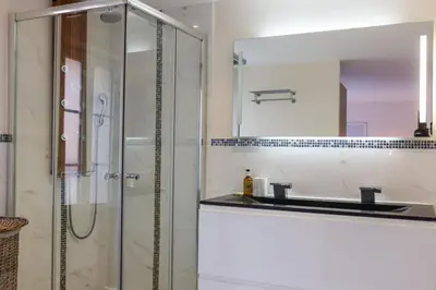 a bathroom with a shower and a sink and a mirror at IMMOGROOM - Bright and Cosy - SUQUET - next to the beaches - AC in Cannes