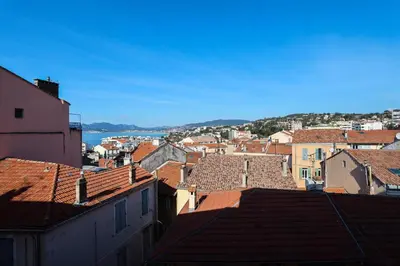 a view of a city with roofs and the water at IMMOGROOM - Bright and Cosy - SUQUET - next to the beaches - AC in Cannes