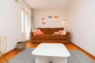 a living room with a couch and a table at IMMOGROOM - Bright and Cosy - SUQUET - next to the beaches - AC in Cannes