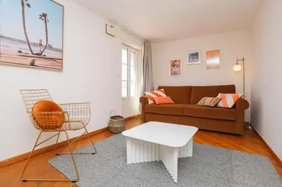 a living room with a couch and a table at IMMOGROOM - Bright and Cosy - SUQUET - next to the beaches - AC in Cannes