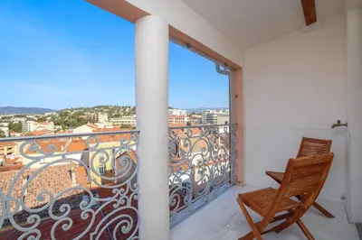 a balcony with a view of a city at IMMOGROOM - Terrace with sea view - AC - Suquet - 5 min from the beach in Cannes