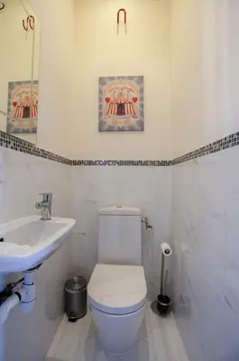 a white bathroom with a toilet and a sink at IMMOGROOM - Terrace with sea view - AC - Suquet - 5 min from the beach in Cannes