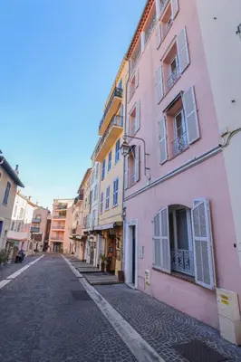 an empty street in a city with colorful buildings at IMMOGROOM - Terrace with sea view - AC - Suquet - 5 min from the beach in Cannes