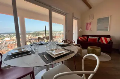 a dining room with a table and chairs with a view at IMMOGROOM - Terrace with sea view - AC - Suquet - 5 min from the beach in Cannes