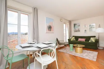 a living room with a table and chairs and a couch at IMMOGROOM - Beautiful and Cosy - Air conditioner - 5 min from beaches in Cannes