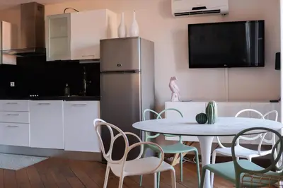 a kitchen and dining room with a table and chairs at IMMOGROOM - Beautiful and Cosy - Air conditioner - 5 min from beaches in Cannes
