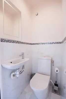 a white bathroom with a toilet and a sink at IMMOGROOM - Beautiful and Cosy - Air conditioner - 5 min from beaches in Cannes