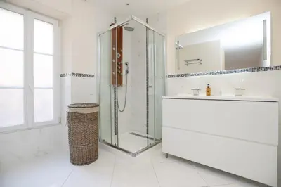 a white bathroom with a shower and a sink at IMMOGROOM - Beautiful and Cosy - Air conditioner - 5 min from beaches in Cannes