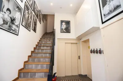 a hallway with stairs and pictures on the walls at IMMOGROOM - Beautiful and Cosy - Air conditioner - 5 min from beaches in Cannes