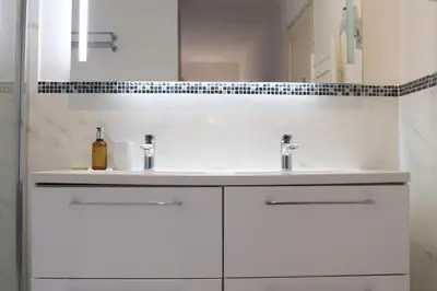 a white bathroom with two sinks and a mirror at IMMOGROOM - Beautiful and cosy- Suquet- near the beaches - AC in Cannes