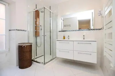 a white bathroom with a shower and a sink at IMMOGROOM - Beautiful and cosy- Suquet- near the beaches - AC in Cannes