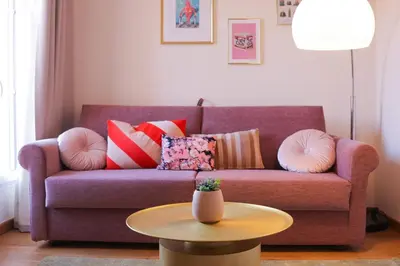 a purple couch with pillows and a table in a living room at IMMOGROOM - Beautiful and cosy- Suquet- near the beaches - AC in Cannes