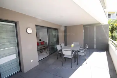 a dining room with a table and chairs on a balcony at HSUD0118 Terracotta in Cannes