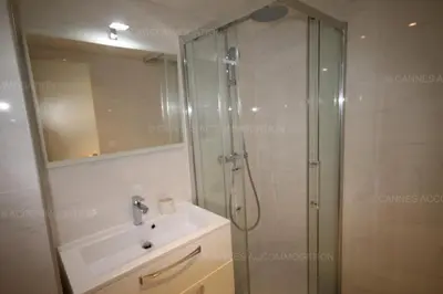 a bathroom with a shower and a sink and a mirror at HSUD0118 Terracotta in Cannes