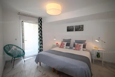 a bedroom with a bed and a large window at HSUD0118 Terracotta in Cannes