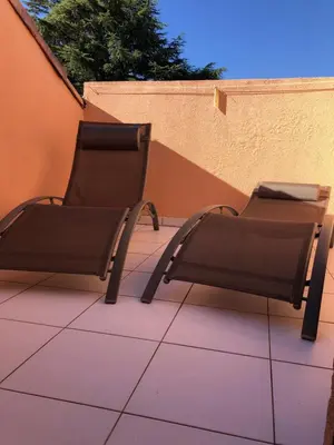 two chairs and a table on a patio at CANNES Appartement Duplex Piscine VUE Mer WIFI PARKING CLIM in Cannes