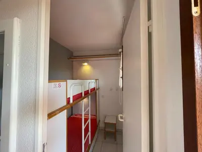 a small kitchen with a refrigerator in a room at CANNES Appartement Duplex Piscine VUE Mer WIFI PARKING CLIM in Cannes