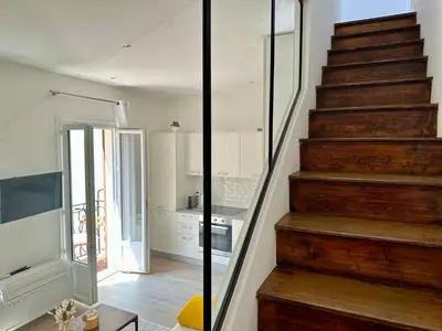 a staircase in a room with a kitchen and a stair case at Maison La Casetta (2ch / 2sdb) - Le Suquet Cannes in Cannes