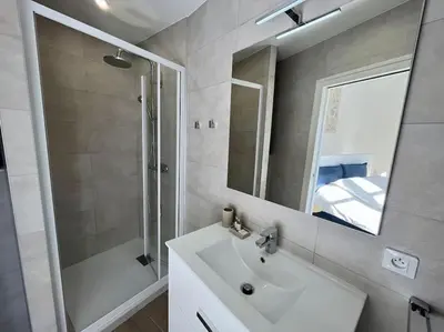 a bathroom with a sink and a shower and a mirror at Maison La Casetta (2ch / 2sdb) - Le Suquet Cannes in Cannes