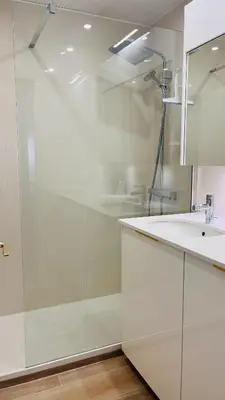 a white bathroom with a shower and a sink at le meilleur de Cannes au palm beach in Cannes