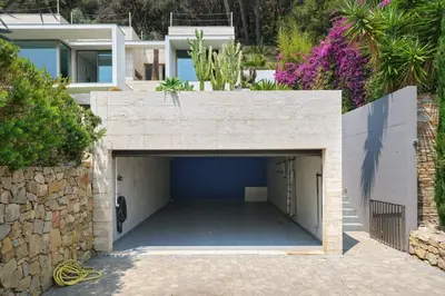 a garage in a house with a stone wall at Cannes - Modern villa with 180° sea view in Vallauris