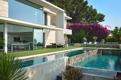 a swimming pool in the backyard of a house at Cannes - Modern villa with 180° sea view in Vallauris