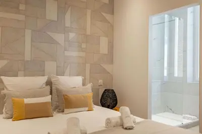 a bedroom with a bed with a wooden wall at Beautiful renovated residence near Croisette in Cannes