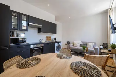 a kitchen and living room with a table and chairs at Beautiful renovated residence near Croisette in Cannes