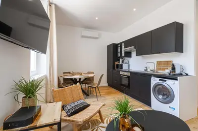 a kitchen and living room with a washer and dryer at Beautiful renovated residence near Croisette in Cannes
