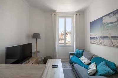 a living room with a couch and a tv at Beautiful renovated residence near Croisette in Cannes
