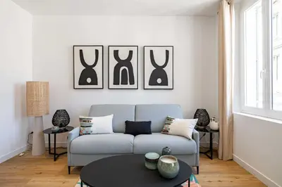 a living room with a couch and a table at Beautiful renovated residence near Croisette in Cannes