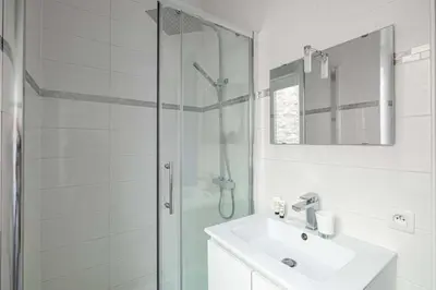 a white bathroom with a sink and a shower at Beautiful renovated residence near Croisette in Cannes