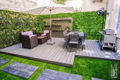 a patio with a table and chairs and an umbrella at Le loft Cannes in Cannes