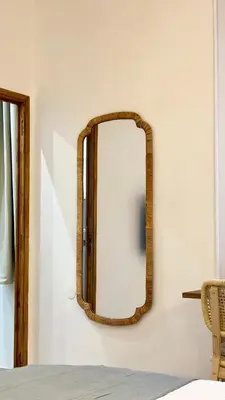 a mirror with a wooden frame on a wall at La Bohème Cosy Apt Near Beach AC Near festival in Cannes