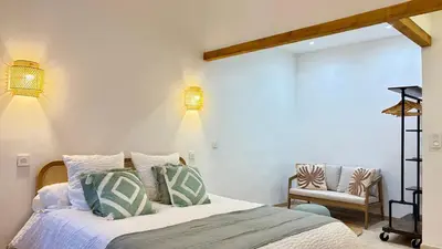 a bedroom with a bed and a chair at La Bohème Cosy Apt Near Beach AC Near festival in Cannes
