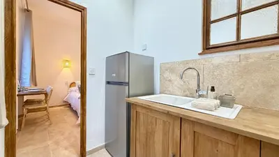a kitchen with a sink and a refrigerator at La Bohème Cosy Apt Near Beach AC Near festival in Cannes