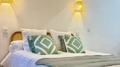 a bedroom with a bed with pillows on it at La Bohème Cosy Apt Near Beach AC Near festival in Cannes