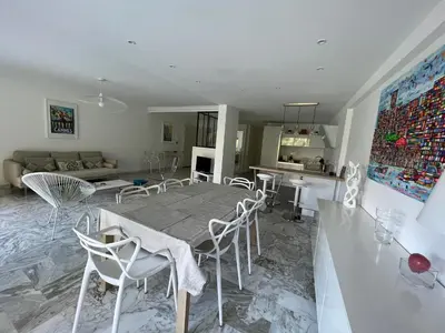 a dining room and living room with a table and chairs at CANNES Martinez- family apartment 100m2 in Cannes