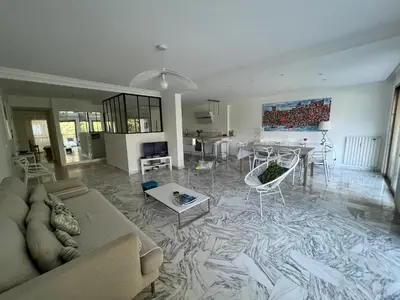 a living room with a couch and a table at CANNES Martinez- family apartment 100m2 in Cannes