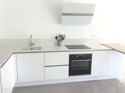 a white kitchen with a sink and a stove at CANNES Martinez- family apartment 100m2 in Cannes