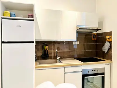a kitchen with white cabinets and a sink at L'écrin - 2 pièces - Le Suquet in Cannes