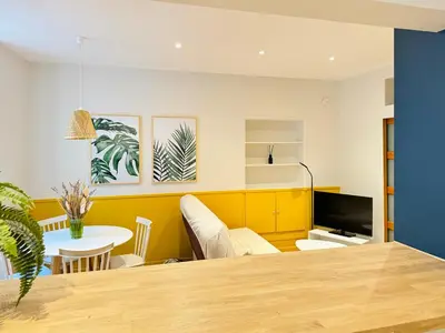 a dining room with a table and a tv at L'écrin - 2 pièces - Le Suquet in Cannes