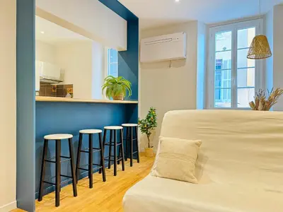a bedroom with a bed and stools in a room at L'écrin - 2 pièces - Le Suquet in Cannes