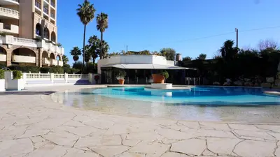 a swimming pool in the middle of a building at Appartement 556, Vue Mer et piscine By Palmazur Vacances in Cannes