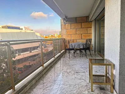 a balcony with a table and chairs on a building at No.6 La Croisette in Cannes