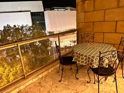 a balcony with a table and chairs and a window at No.6 La Croisette in Cannes
