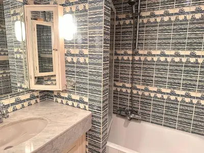 a bathroom with a tub and a sink and a mirror at No.6 La Croisette in Cannes
