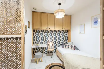 a bedroom with a bed and a table with a chair at C16 - 2 BDR Rue Antibes 4 min Palais Festivals - AC & Terrace in Cannes