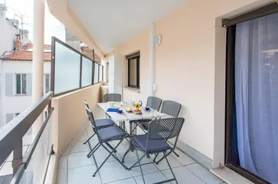 a small balcony with a table and chairs on it at C16 - 2 BDR Rue Antibes 4 min Palais Festivals - AC & Terrace in Cannes