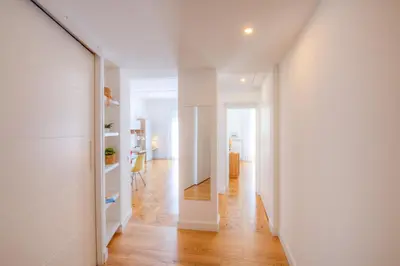 a hallway with white walls and a wooden floor at Palais Miramar in Cannes
